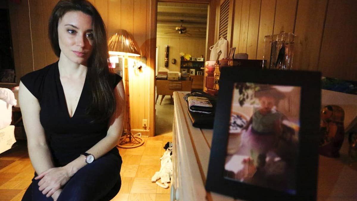 In this Feb. 13, 2017 photo, Casey Anthony poses for a portrait next to a photo of her daughter, Caylee, in her West Palm Beach, Fla., bedroom. In an exclusive interview with The Associated Press, Anthony claims the last time she saw Caylee she “believed that she was alive and that she was going to be OK.” (AP Photo/Joshua Replogle)