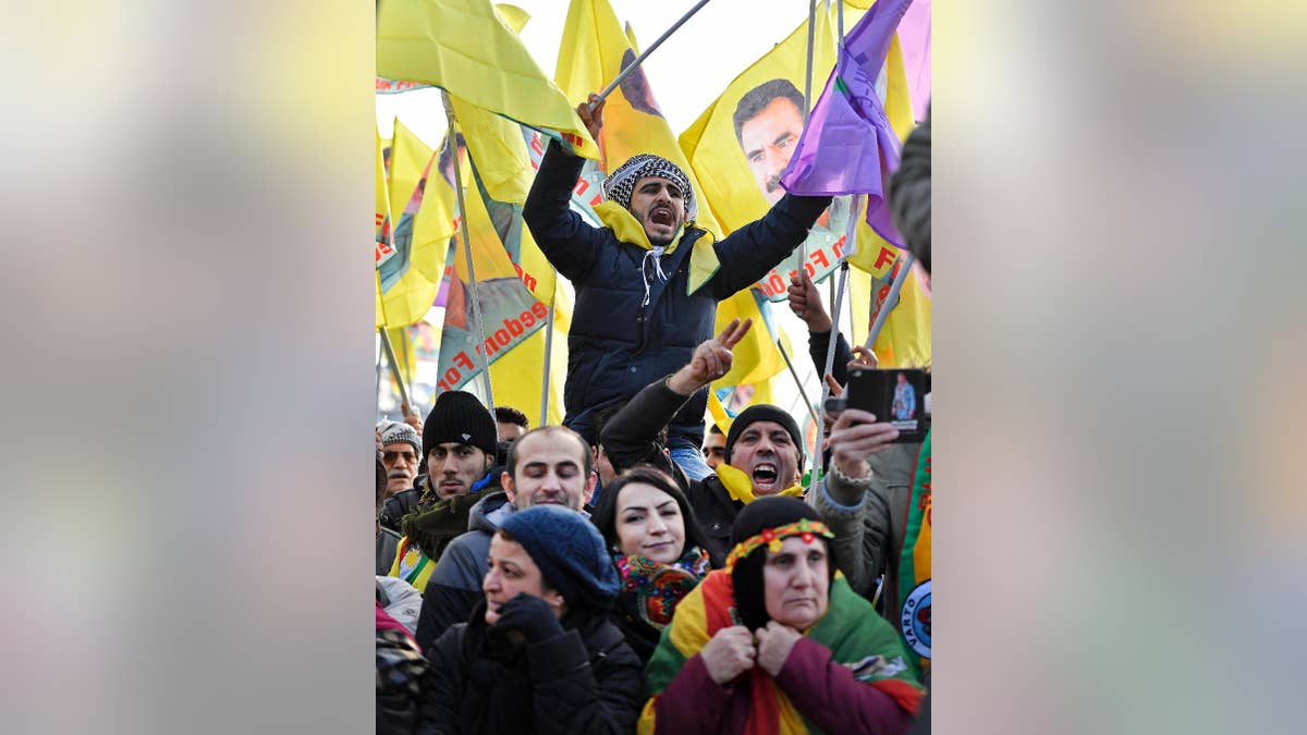 Pro-Kurdish demonstrators protest against Turkish president Recep Tayyip Erdogan and the political repression that followed July's failed military coup, in Cologne, Germany Saturday, Nov. 12, 2016. People showing flags of detained Kurdistan Workers Party, PKK , leader Abdullah Ocalan. (AP Photo/Martin Meissner)