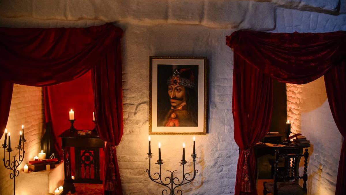 In this picture taken Oct. 9, 2016, a portrait of Vlad the Impaler is hung on a wall in Bran Castle, in Bran, Romania. Airbnb has launched a contest to find two people to stay overnight in the castle on Halloween, popularly known as Dracula’s castle because of its connection to the cruel real-life prince Vlad the Impaler, who inspired the legend of Dracula. (AP Photo/Andreea Alexandru)