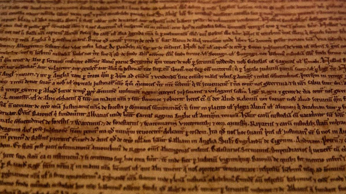 A detail of the Salisbury Magna Carta one of the four original surviving Magna Carta manuscripts that have been brought together by the British Library for the first time, on display at the library during a media preview in London, Monday, Feb. 2, 2015. The event marks the 800th anniversary of the Magna Carta, which established the timeless principle that no individual, even a monarch, is above the law. (AP Photo/Alastair Grant)