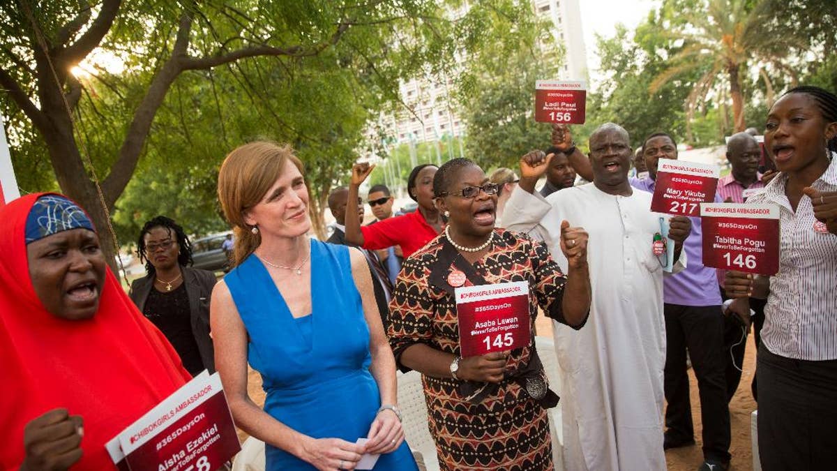 U.S. Ambassador to the United Nations Samantha Power, second from right, stands next to Bring Back Our Girls co-founder Obiageli Ezekwesili, center and Aisha Yesufu, left, as she attends a Bring Back Our Girls vigil in Abuja, Nigeria, Thursday, April 21, 2016, which, two years after Boko Haram abducted the girls from their school, is still held daily. A total of 219 girls remain missing, and Power said she couldn't imagine the frustration of the families. Power is traveling to Cameroon, Chad, and Nigeria to highlight the growing threat Boko Haram poses to the Lake Chad Basin region. (AP Photo/Andrew Harnik)