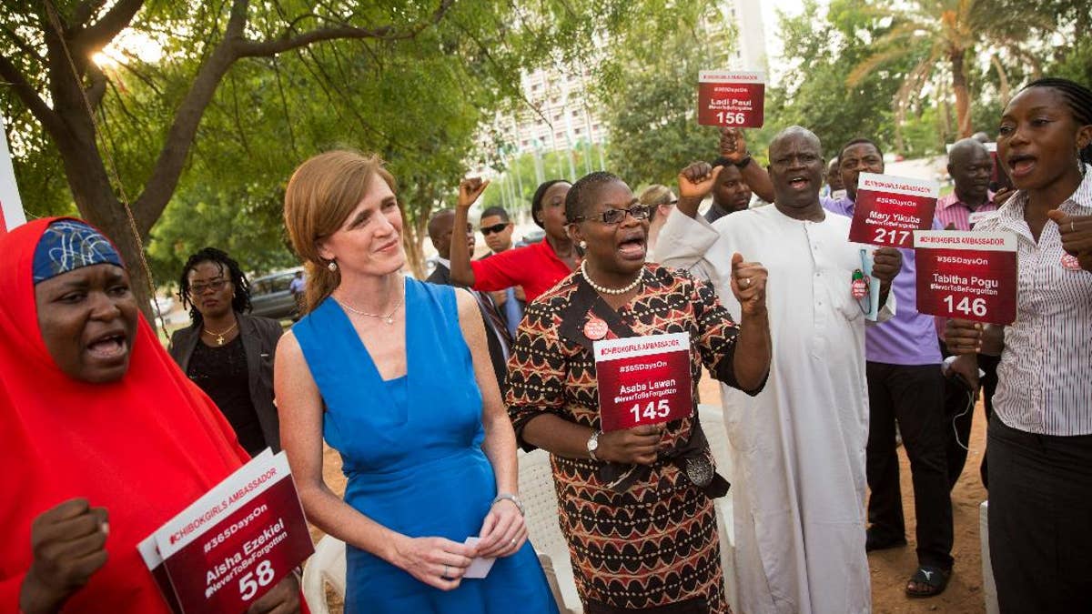 U.S. Ambassador to the United Nations Samantha Power, second from right, stands next to Bring Back Our Girls co-founder Obiageli Ezekwesili, center and Aisha Yesufu, left, as she attends a Bring Back Our Girls vigil in Abuja, Nigeria, Thursday, April 21, 2016, which, two years after Boko Haram abducted the girls from their school, is still held daily. A total of 219 girls remain missing, and Power said she couldn't imagine the frustration of the families. Power is traveling to Cameroon, Chad, and Nigeria to highlight the growing threat Boko Haram poses to the Lake Chad Basin region. (AP Photo/Andrew Harnik)