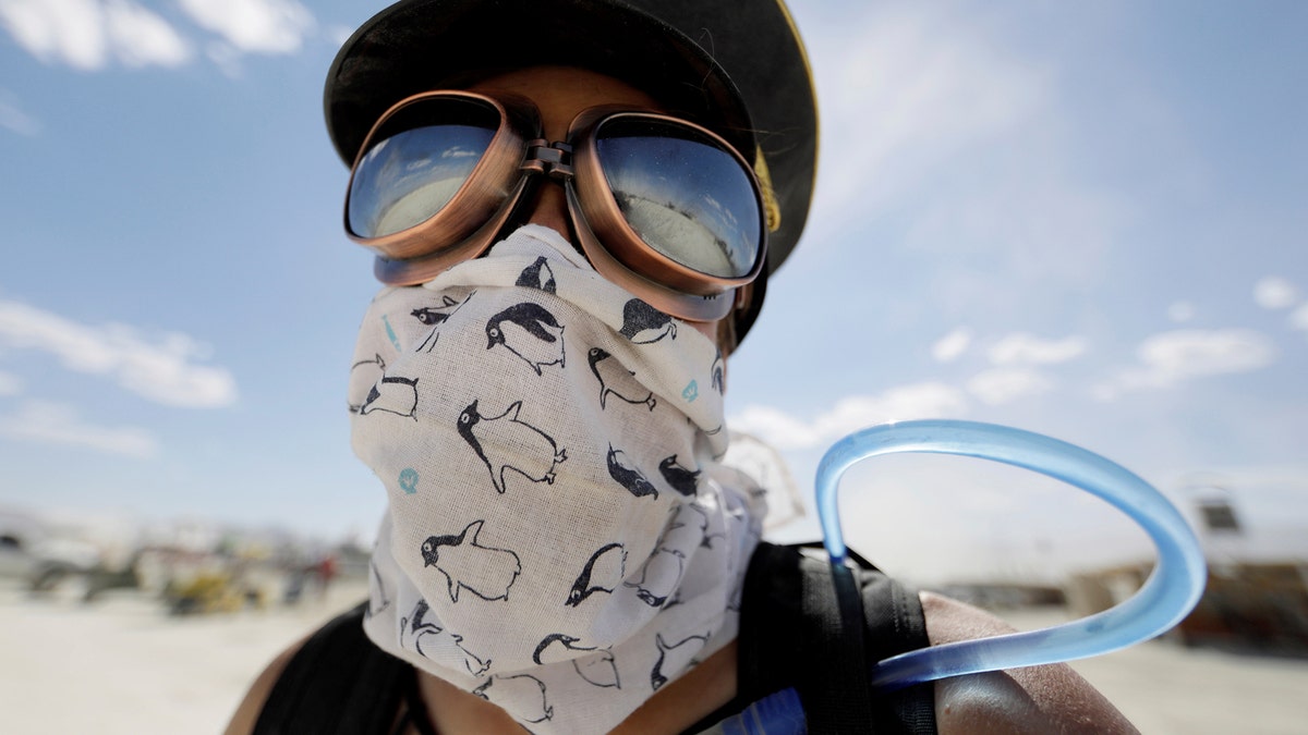 Burning Man participant Marie Sbrocca of San Francisco explores Black Rock City on her bicycle as approximately 70,000 people from all over the world gathered for the 1st full day of the annual Burning Man arts and music festival in the Black Rock Desert of Nevada, U.S. August 28, 2017. REUTERS/Jim Bourg   FOR USE WITH BURNING MAN RELATED REPORTING ONLY. FOR EDITORIAL USE ONLY. NOT FOR SALE FOR MARKETING OR ADVERTISING CAMPAIGNS. NO THIRD PARTY SALES. NOT FOR USE BY REUTERS THIRD PARTY DISTRIBUTORS. - RTX3DREU