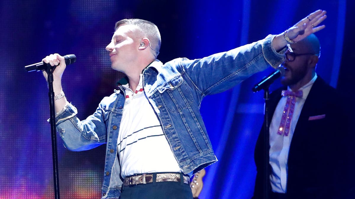 In this Sept. 23, 2017, file photo, Macklemore performs at the 2017 iHeartRadio Music Festival in Las Vegas. U.S. rapper Macklemore is wading into Australia's gay-marriage debate by vowing to sing his marriage equality anthem "Same Love" during a weekend football grand final. (John Salangsang/Invision via AP, File)