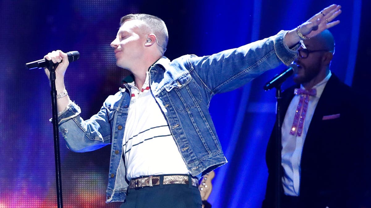 In this Sept. 23, 2017, file photo, Macklemore performs at the 2017 iHeartRadio Music Festival in Las Vegas. U.S. rapper Macklemore is wading into Australia's gay-marriage debate by vowing to sing his marriage equality anthem "Same Love" during a weekend football grand final. (John Salangsang/Invision via AP, File)