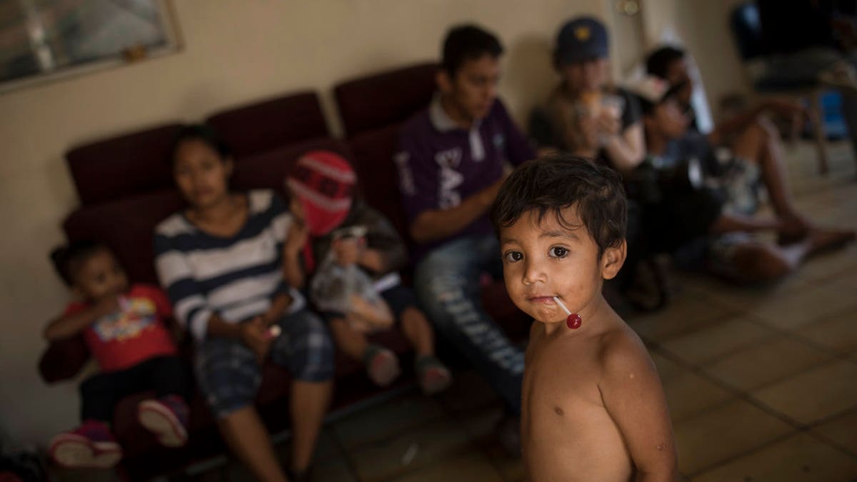 Central American migrants traveling with a caravan of Central American migrants wait to be registered at the ViÃ±a de Cristo shelter in Tijuana, Mexico, Wednesday, April 25, 2018. The caravan of mainly Central American migrants are planning to request asylum, either in the United States or Mexico. (AP Photo/Hans-Maximo Musielik)