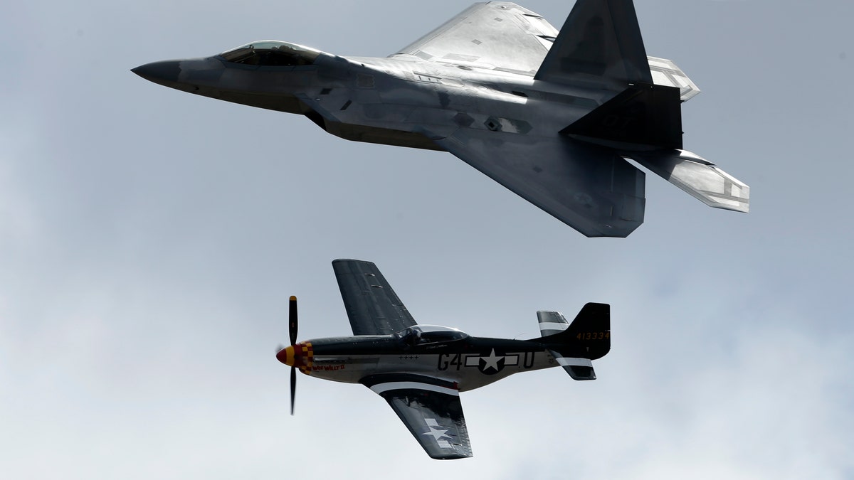 An F-22 Raptor, above, flies with a P-51 Mustang during the Miramar Air Show.