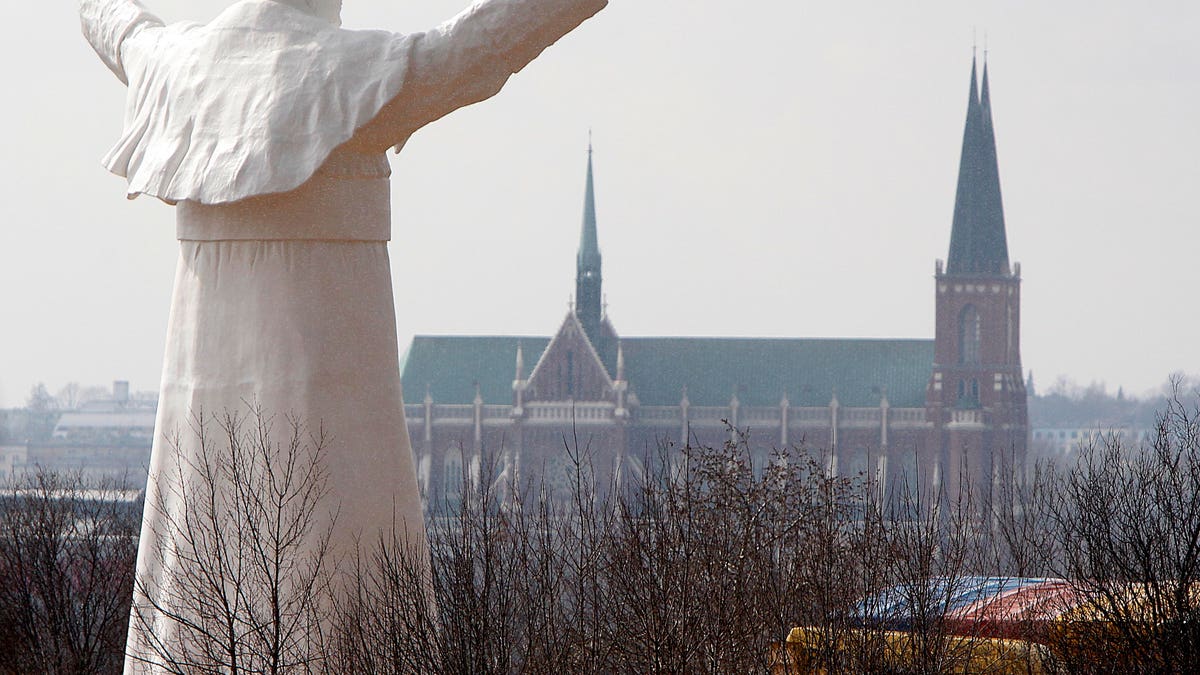 The sculpture of the late Pope John Paul II during the unveiling ceremony in Czestochowa, Poland, on Saturday, April 13, 2013. Archbishop Waclaw Depo unveiled the 13.8-meter (45.3-foot) white fiberglass figure that was funded by a businessman, Leszek Lyson, in gratitude for what he believes was an intervention by the late pontiff in saving his drowning son. (AP Photo/Czarek Sokolowski)