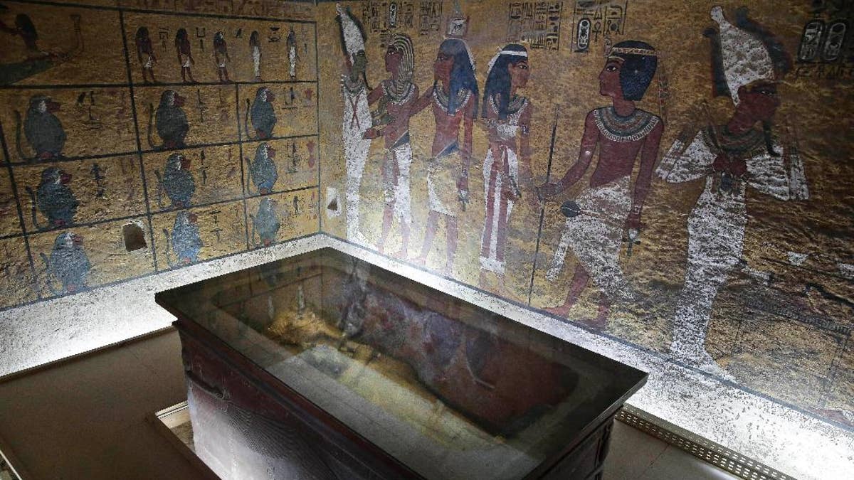 The tomb of King Tut is displayed in a glass case at the Valley of the Kings in Luxor, Egypt, Tuesday, Sept. 29, 2015. Egypt's antiquities minister said King Tut's tomb may contain hidden chambers, lending support to a British Egyptologist's theory that a queen may be buried in the walls of the 3,300 year-old pharaonic mausoleum. (AP Photo/Nariman El-Mofty)