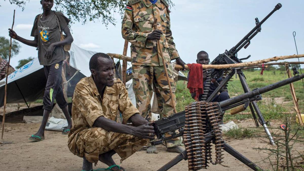 Rebel soldiers guard the village of Majieng, about 6km from the town of Bentiu, in South Sudan Saturday, Sept. 20, 2014. Seyoum Mesfin, the chairman of the South Sudan mediation process said Saturday there is renewed fighting in South Sudan between government and rebel troops and that it is a purposeful act aimed at derailing the next phase of the peace process. (AP Photo/Matthew Abbott)