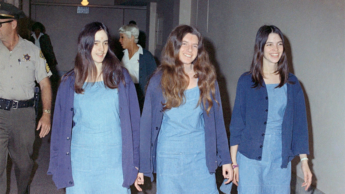 FILE - Charles Manson followers, from left: Susan Atkins, Patricia Krenwinkel and Leslie Van Houten, shown walking to court to appear for their roles in the 1969 cult killings of seven people, including pregnant actress Sharon Tate, in Los Angeles, Calif., in this Aug. 20, 1970 file photo. 44 years after she went to prison, Leslie Van Houten is an old woman with gray hair and wrinkles and she is facing her 20th parole hearing Wednesday June 5, 2013 with multiple forces arrayed against her bid for a chance at freedom in her old age. (AP Photo/George Brich, File)