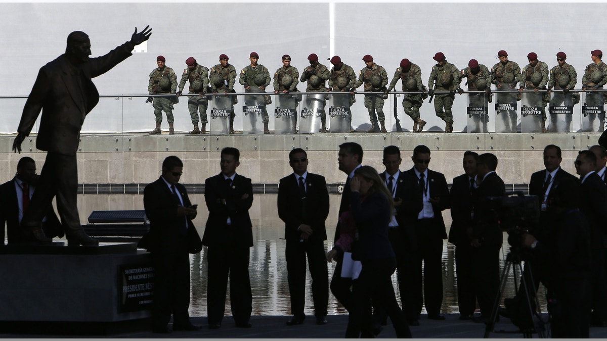 Security personnel guard the Unasur building during the IV Summit of the Community of Latin American and Caribbean States, CELAC, in Quito, Ecuador, Wednesday, Jan. 27, 2016. The Dominican Republic will take over the rotating presidency of the CELAC from Ecuador, during the summit. (AP Photo/Dolores Ochoa)
