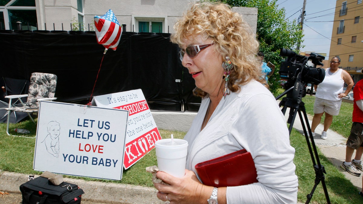 July 2- Jackson Women's Health Organization owner Diane Derzis, walks past abortion opponents protesting outside Mississippi's only abortion clinic in Jackson, Miss. 