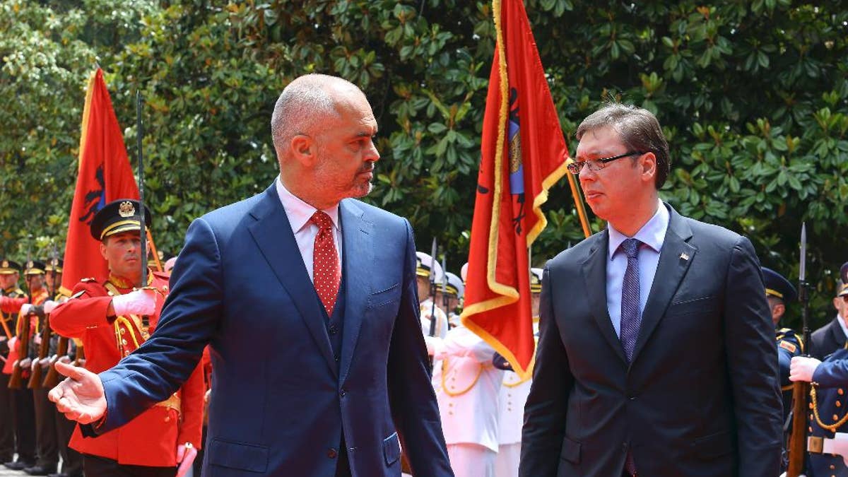 Albanian Prime Minister Edi Rama, left, welcomes Serbian Prime Minister Aleksandar Vucic, the first Serbian leader to visit the nation after a troubled past, as they walk along the red carpet at the Palace of Brigades, in Tirana, Albania, Wednesday, May 27, 2015. The visit is held under tight security measures with some 1,300 policemen guarding capital Tirana, police and army helicopters hovering over the air and streets downtown Tirana blocked. Vucic’s arrival on Wednesday follows Albanian Prime Minister Edi Rama’s visit to Belgrade in November, the first by an Albanian head of government to Serbia in 68 years. (AP Photo/Hektor Pustina)