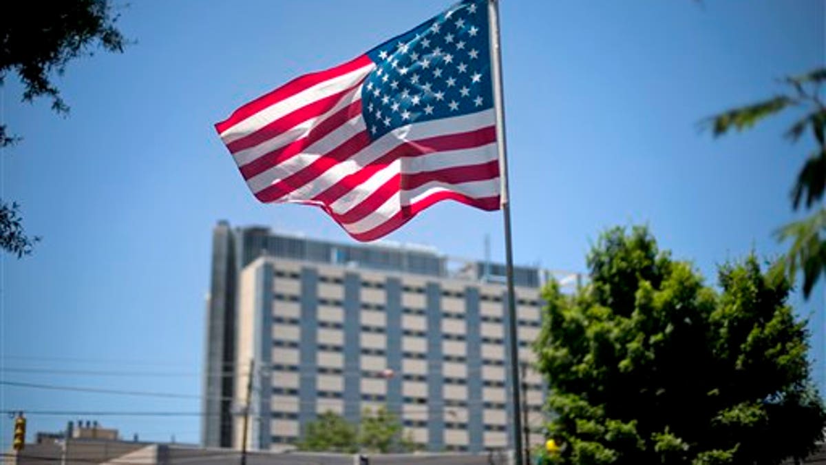 FILE - In this May 24, 2013, file photo, an American flag flies in front of the Atlanta VA Medical Center in Atlanta. After two overwhelming votes in two days, congressional lawmakers say they are confident they can agree on a bill to improve veterans health care and send it to the presidents desk by the end of the month. (AP Photo/David Goldman, File)