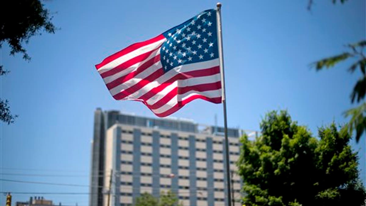 FILE - In this May 24, 2013, file photo, an American flag flies in front of the Atlanta VA Medical Center in Atlanta. After two overwhelming votes in two days, congressional lawmakers say they are confident they can agree on a bill to improve veterans health care and send it to the presidents desk by the end of the month. (AP Photo/David Goldman, File)