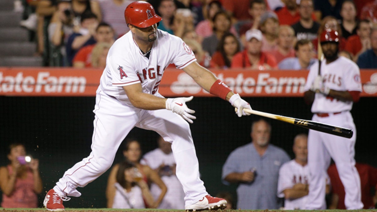Los Angeles Angels' Albert Pujols hits a three-run double during the third inning of a baseball game against the Seattle Mariners Monday, Sept. 15, 2014, in Anaheim, Calif. (AP Photo/Jae C. Hong)