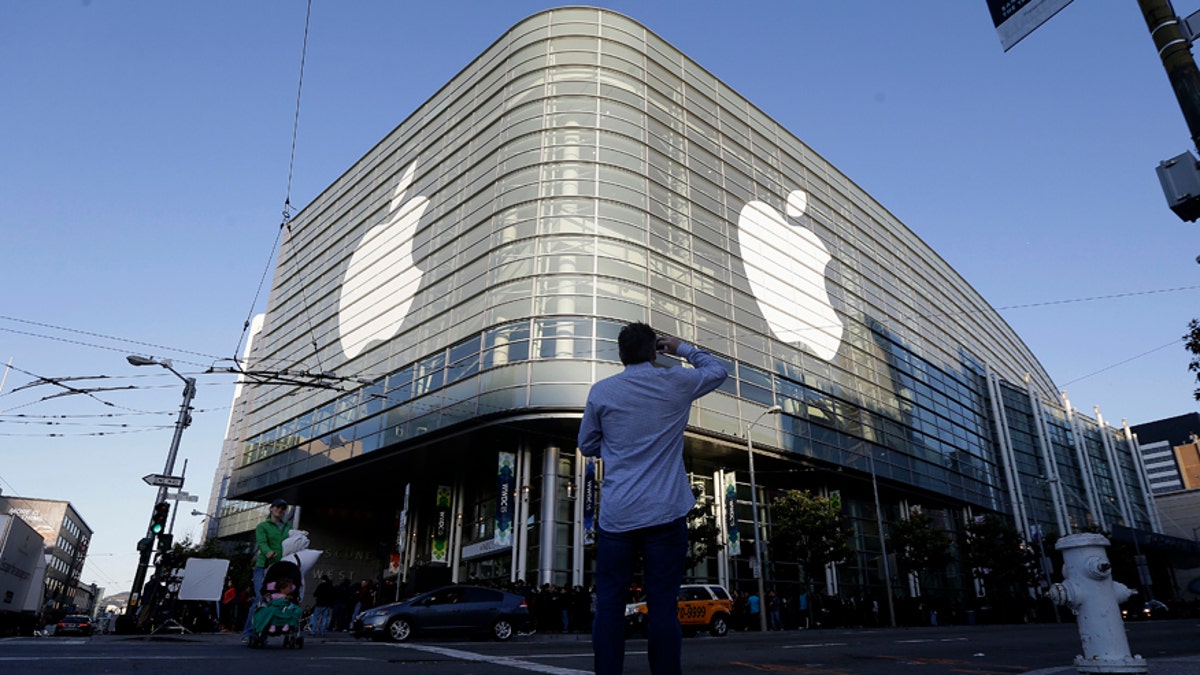Apple logos adorn the exterior of the Moscone West building on the first day of the Apple Worldwide Developers Conference in San Francisco, Monday, June 8, 2015. 