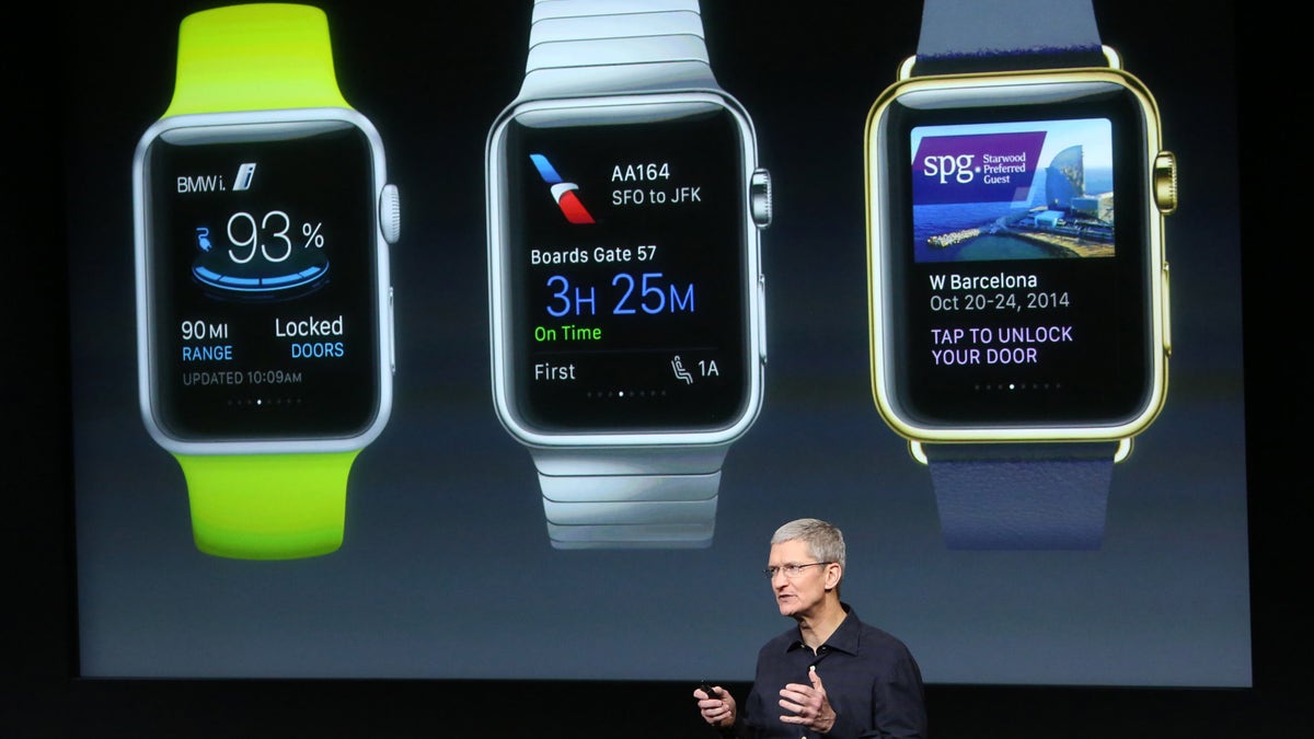 Apple CEO Tim Cook stands in front of a screen displaying apps available for the Apple Watch at a presentation at Apple headquarters in Cupertino, California October 16, 2014. 