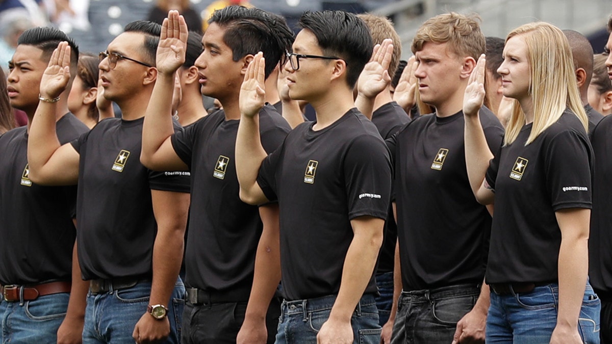 In this June 4, 2017, file photo. nNew Army recruits take part in a swearing in ceremony before a baseball game between the San Diego Padres and the Colorado Rockies in San Diego
