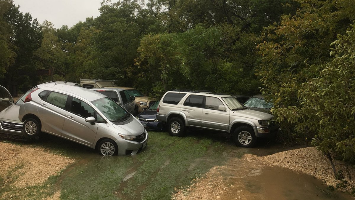 The fast-moving floodwaters were so strong, vehicles were swept away and ended up piled up.