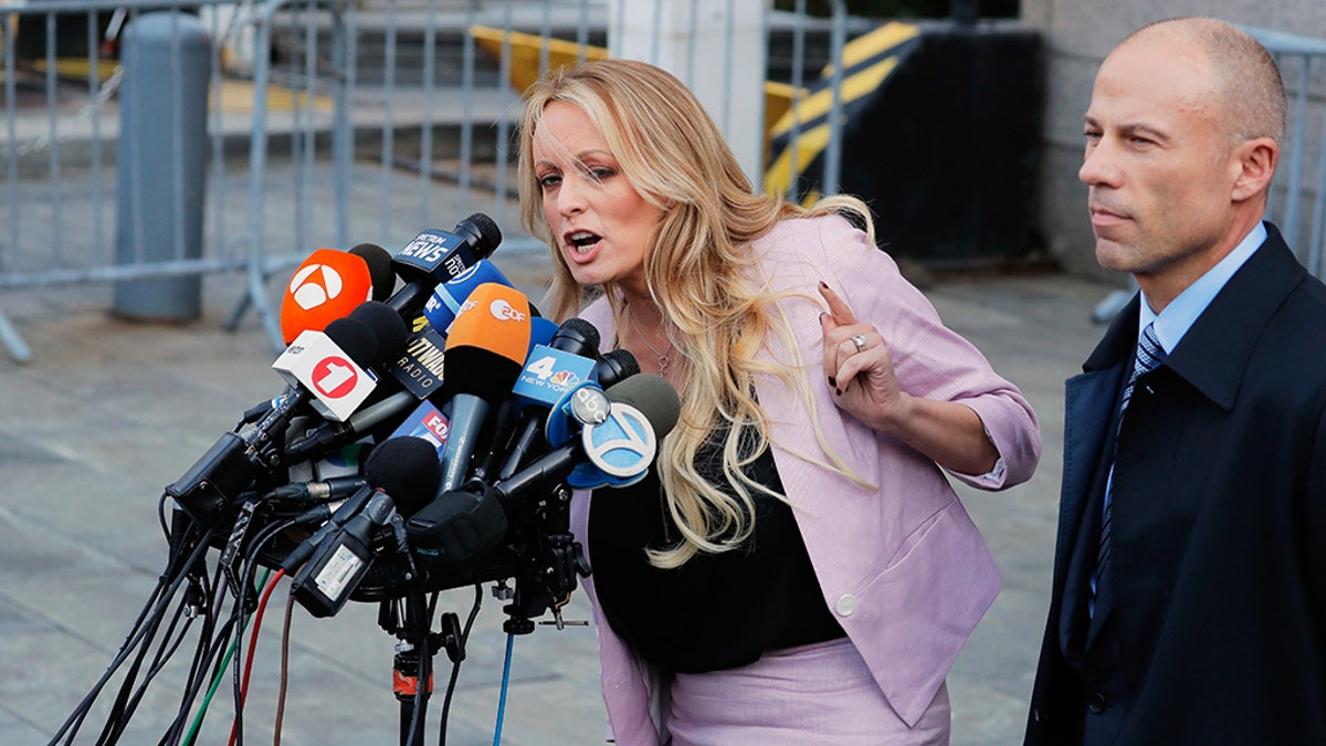 Adult film actress Stephanie Clifford, also known as Stormy Daniels, speaks to media along with lawyer Michael Avenatti (R) outside federal court in the Manhattan borough of New York City, New York, U.S., April 16, 2018. REUTERS/Lucas Jackson - HP1EE4G1NGLO1