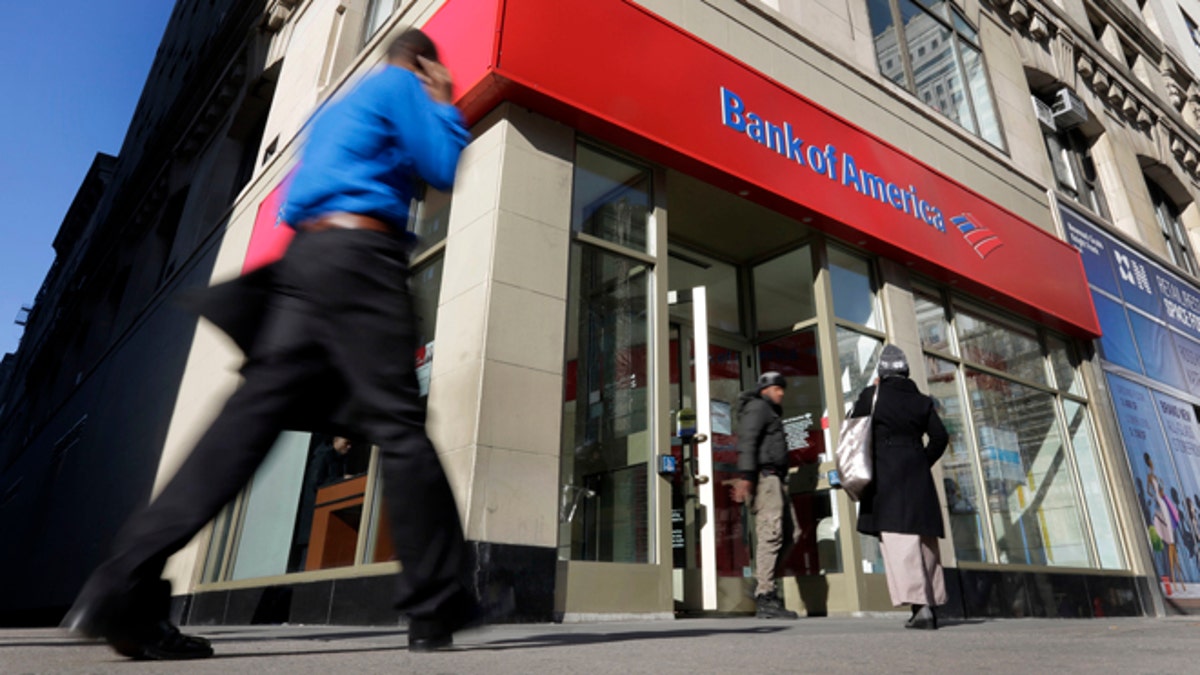FILE- In this Monday, Jan. 7, 2013 file photo, people pass a Bank of America branch in New York. Bank of America Corp. reports quarterly financial results before the market opens on Wednesday, April 17, 2013. (AP Photo/Richard Drew, File)
