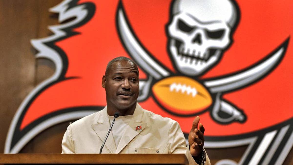 Former Tampa Bay Buccaneers linebacker Derrick Brooks gestures during a news conference Tuesday, May 6, 2014, in Tampa, Fla., after it was announced that he would be inducted into the team's Ring of Honor. Brooks played 14 season with the Buccaneers. (AP Photo/Chris O'Meara)