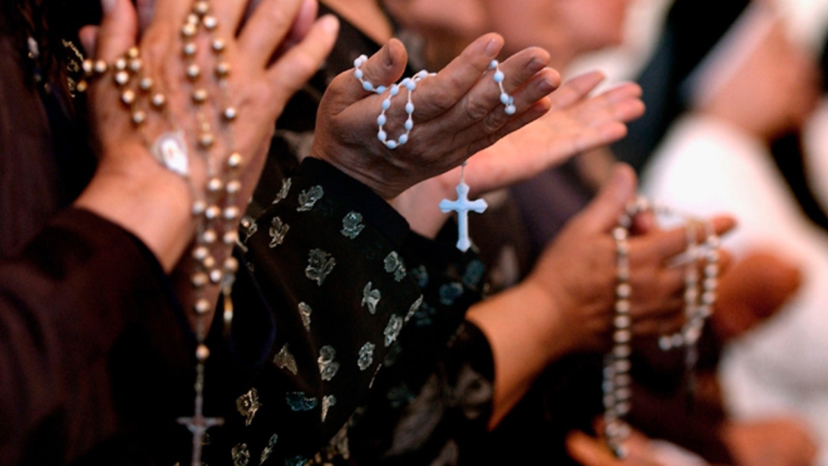 People praying with rosaries
