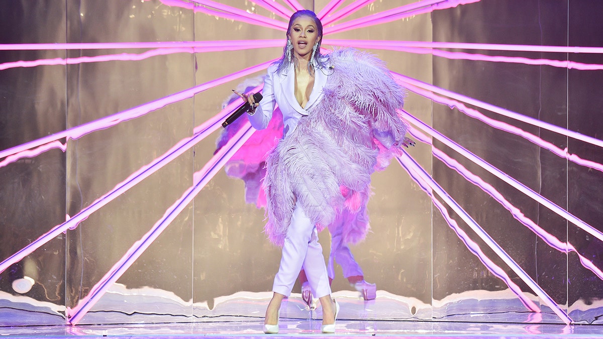 PARIS, FRANCE - SEPTEMBER 25: Cardi B performs during the ETAM show as part of the Paris Fashion Week Womenswear Spring/Summer 2019 on September 25, 2018 in Paris, France. (Photo by Stephane Cardinale - Corbis/Corbis via Getty Images)