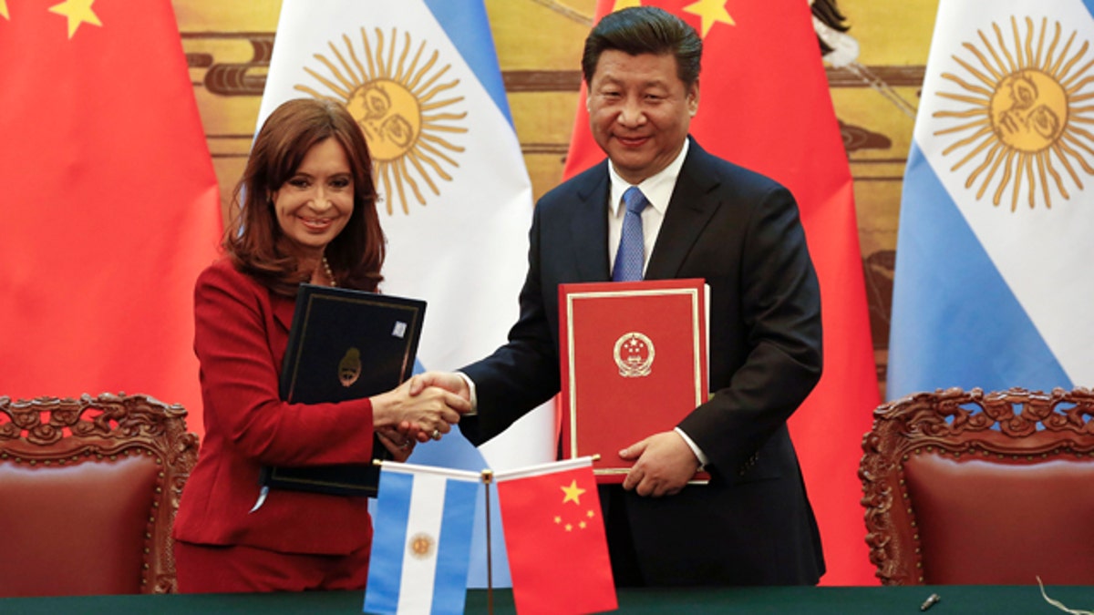 Feb. 4, 2015: Chinese President Xi Jinping, right, and Argentinian President Cristina Fernandez shake hands after signing documents following their meeting at the Great Hall of the People in Beijing. (AP Photo/Rolex Dela Pena)