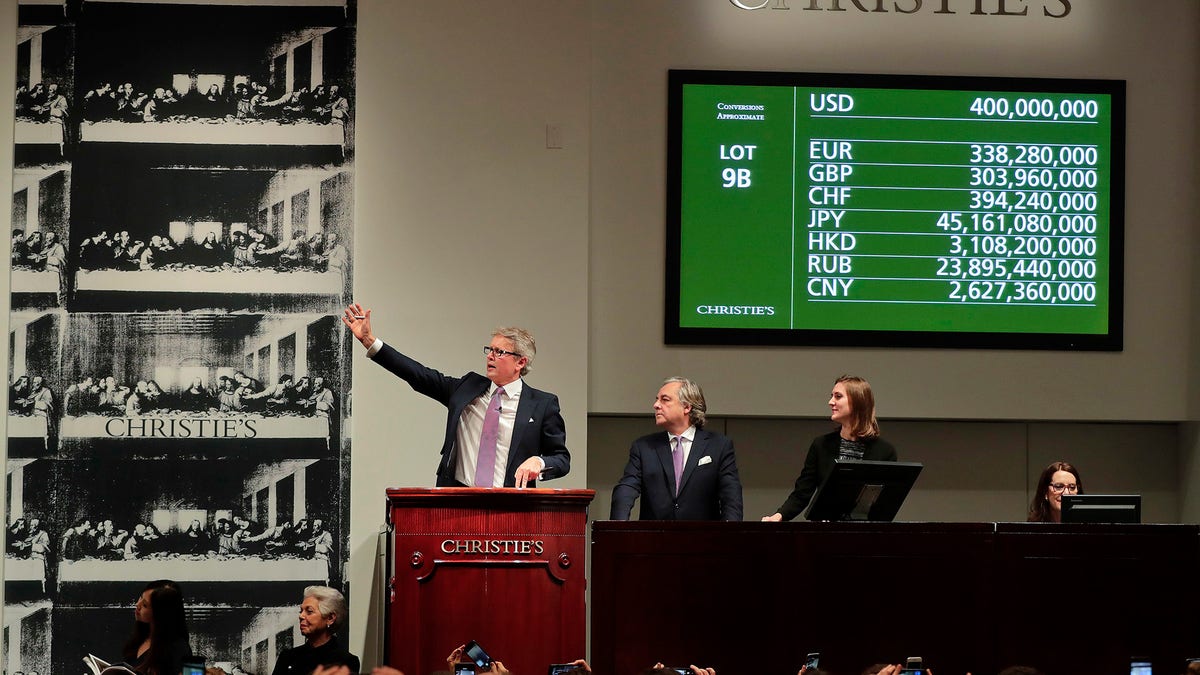 CORRECTS PRICE - Christie's auctioneer Jussi Pylkannen, left, looks for one last bid for Leonardo da Vinci's 