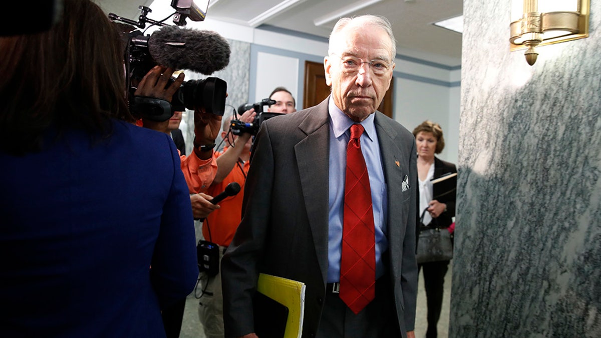 Sen. Chuck Grassley, R-Iowa, center, chair of the Senate Judiciary Committee, arrives for a Senate Finance Committee hearing, Wednesday, Sept. 26, 2018, on Capitol Hill in Washington. Grassley was asked questions by reporters about allegations of sexual misconduct against Supreme Court nominee Brett Kavanaugh. (AP Photo/Jacquelyn Martin)