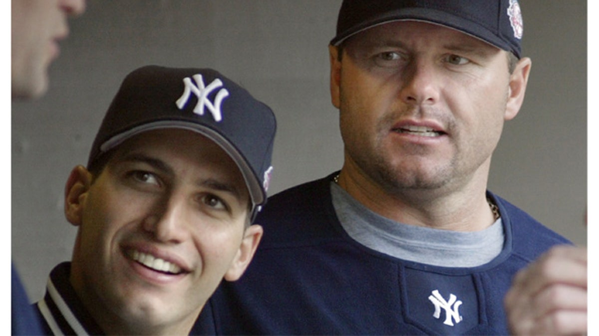 New York Yankees pitchers Andy Pettitte, left, and Roger Clemens talking with a teammate during a baseball game against the Detroit Tigers, in Detroit.