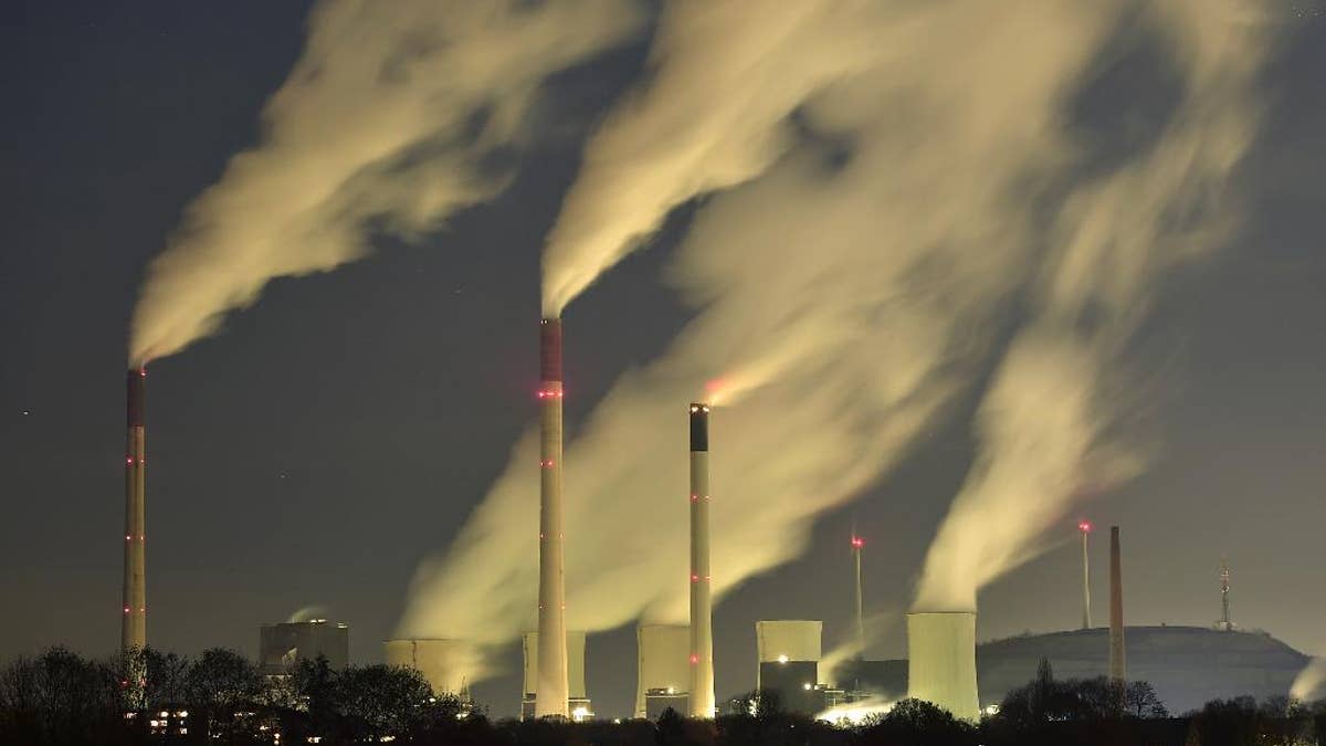 FILE - In this Nov. 24, 2014 file photo, smoke streams from the chimneys of the E.ON coal-fired power station in Gelsenkirchen, Germany. The U.N. weather agency says levels of carbon dioxide and methane, the two most important greenhouse gases, reached record highs last year. Pushed by the burning of coal, oil and gas for energy, global CO2 levels are now 143 percent higher than before the industrial revolution and scientists say that’s the main driver of global warming. (AP Photo/Martin Meissner, File)