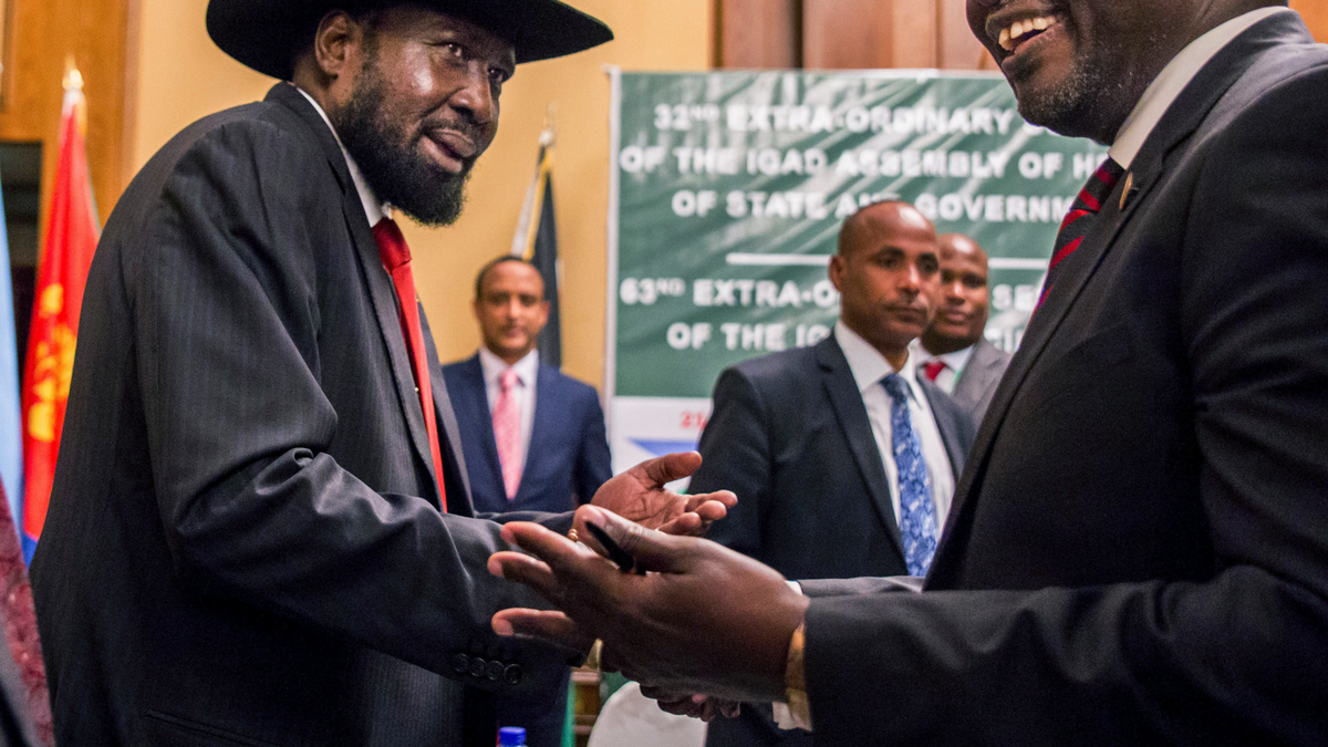 In this Thursday, June 21, 2018 file photo, South Sudan's President Salva Kiir, left, and opposition leader Riek Machar, right, shake hands during peace talks in Addis Ababa, Ethiopia. 