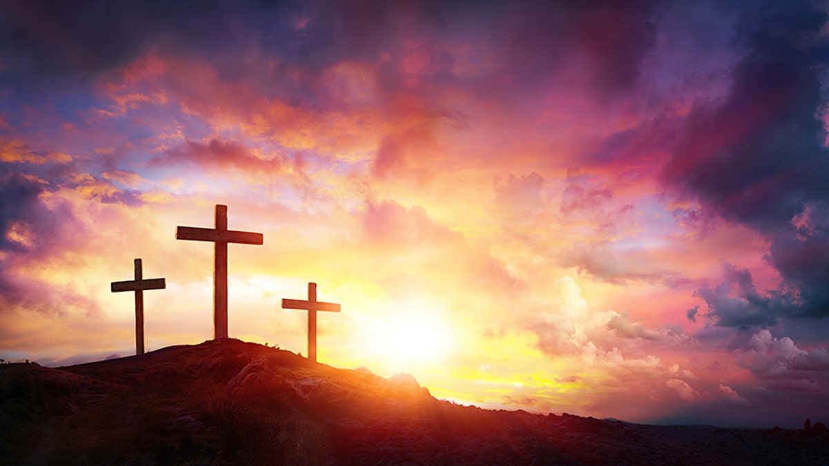 Three Crosses On Mountain With Red Clouds