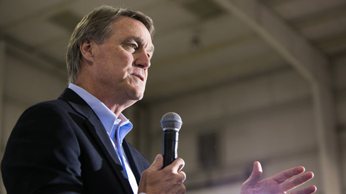 ATLANTA, GA - NOVEMBER 03: Republican candidate for U.S. Senate David Perdue (R) speaks at a campaign stop one day before the mid-term elections at Peachtree Dekalb Airport on November 3, 2014 in Atlanta, Georgia. Perdue is in a tight race with Democratic challenger Michelle Nunn. (Photo by Jessica McGowan/Getty Images)