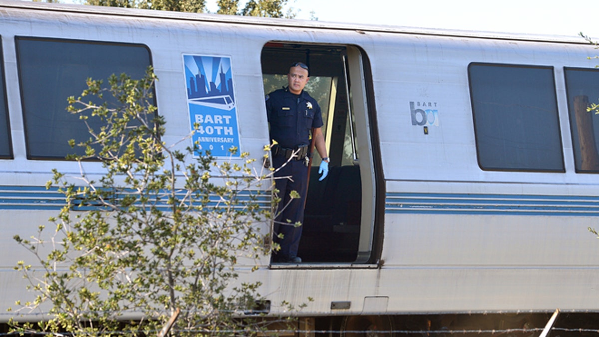 Oct. 19, 2013: A BART police officer looks out of a BART car that struck and killed two people along Jones Road in Walnut Creek, Calif.