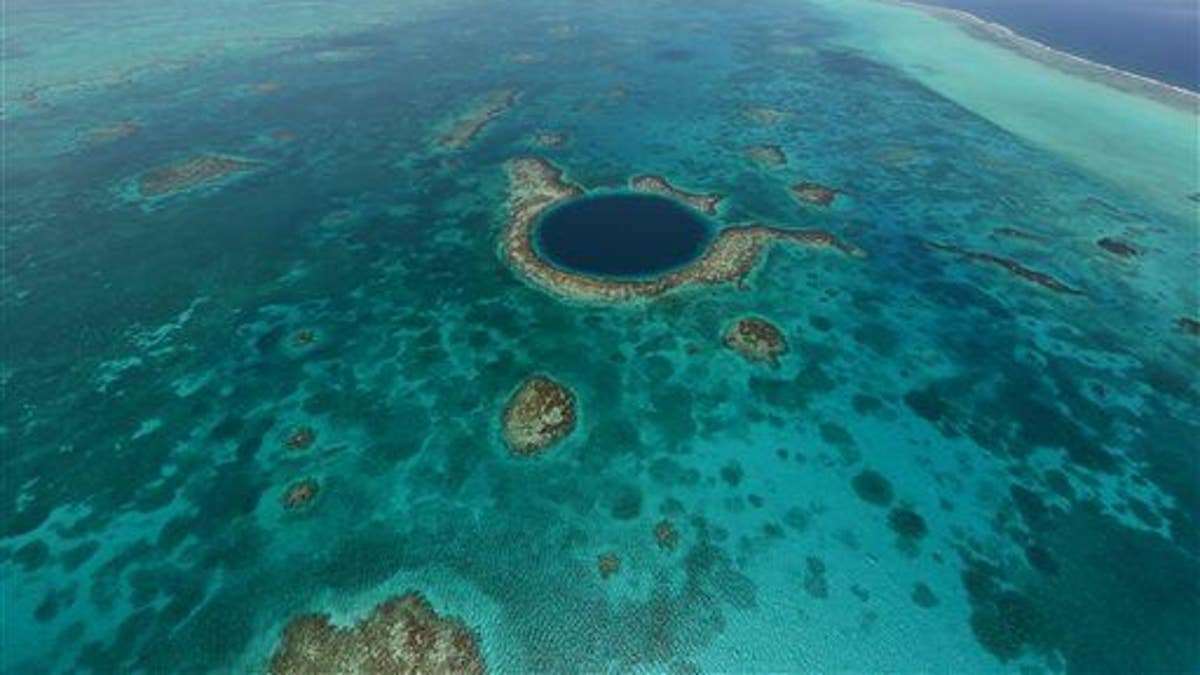 This undated image provided by the Belize Tourist Board shows an aerial view of the Great Blue Hole, a popular diving site that's part of Belize���s barrier reef.