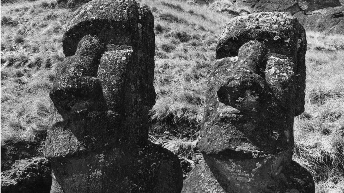 circa 1955:  Two ancient statues of uncertain origin on Easter Island, in the South Pacific Ocean.  (Photo by Richard Harrington/Three Lions/Getty Images)