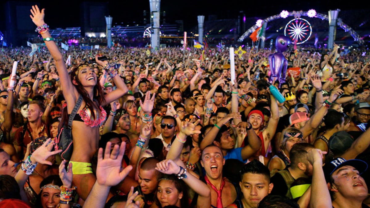 FILE - In this Saturday, June 21, 2014 file photo, carnival goers dance to music by Krewella at the Electric Daisy Carnival in Las Vegas. Organizers of the Electric Daisy Carnival music festival which is winding down its dance party beats at the Las Vegas Motor Speedway June 21, 2015, are among event producers fearing a new tax provision could spell trouble for their festivals futures. Nevada lawmakers recently passed a bill that slaps a 9 percent tax on admissions to live entertainment events. (AP Photo/John Locher,File)