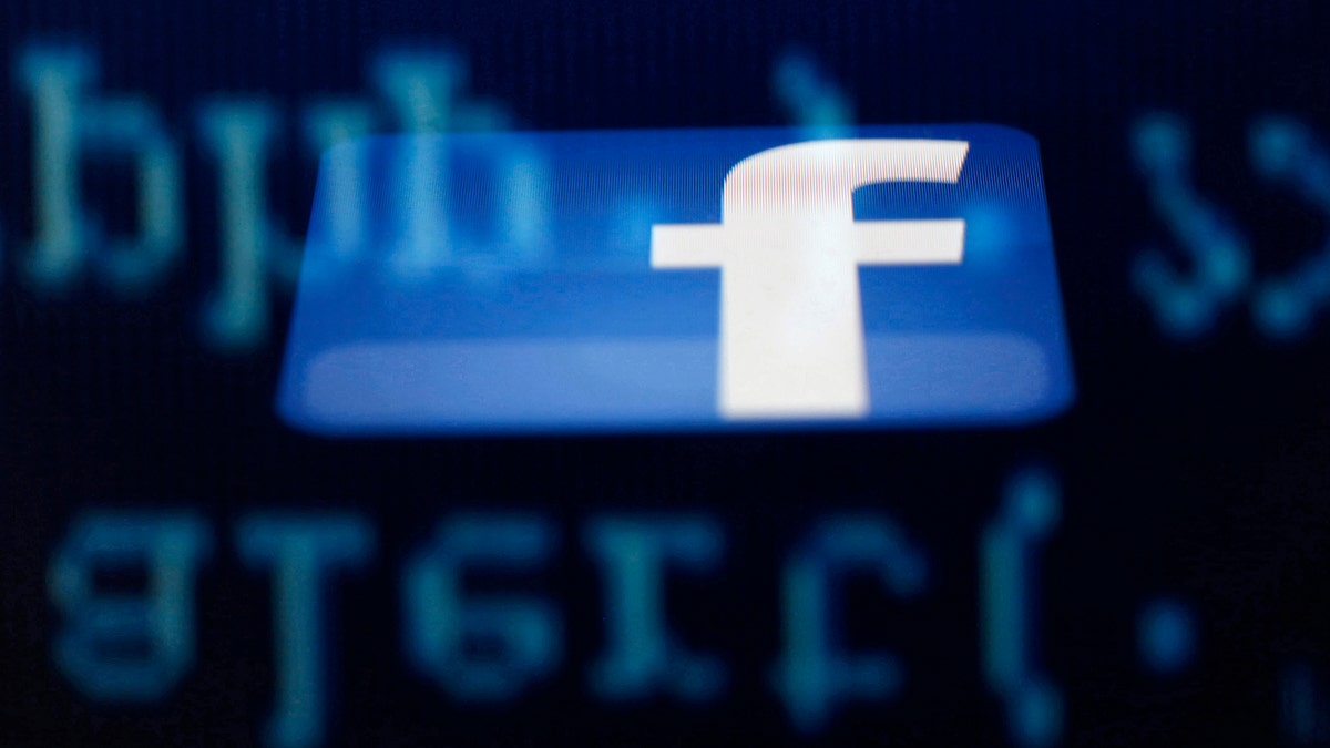 File photo - A Facebook logo on an Ipad is reflected among source code on the LCD screen of a computer, in this photo illustration taken in Sarajevo June 18, 2014.