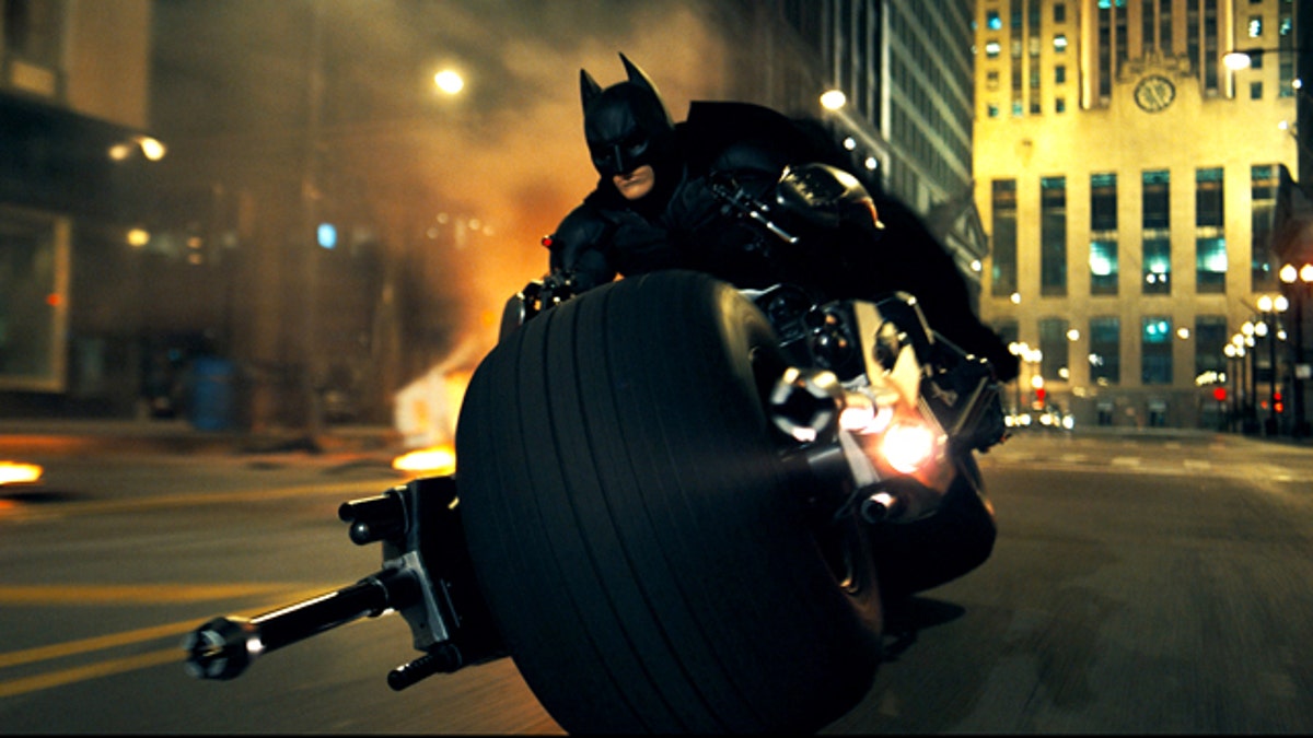 Christian Bale rides a very custom chopper as Batman in a scene from