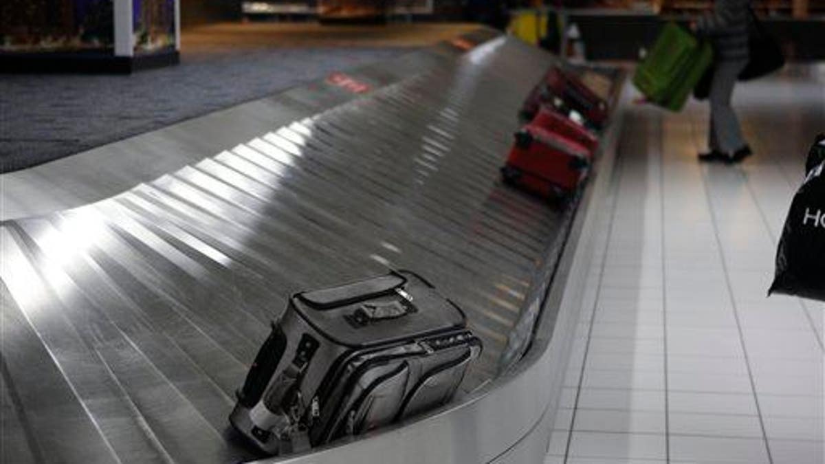 In this Oct. 27, 2009 file photo, a piece of luggage is seen on a baggage carousel.