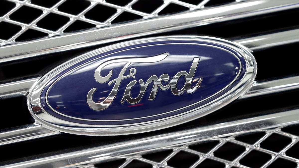 FILE - In this Jan. 5, 2015, file photo, the Ford logo shines on the front grille of a 2014 Ford F-150, on display at a local dealership in Hialeah, Fla. Ford will build a new $1.6 billion factory in Mexico, creating about 2,800 jobs and shifting small-car production from the U.S. The announcement Tuesday, April 5, 2016 comes at a time when moving jobs to the south has become a major issue in the U.S. presidential campaign. (AP Photo/Alan Diaz, File)