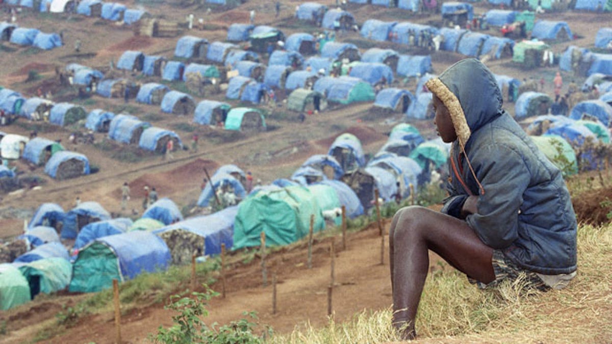 FILE - In this Aug. 25, 1994 file photo a young Tutsi refugee gazes upon the Tutsi camp of Nyarushishi, Rwanda, 6 miles southeast of Cyangugu. Two decades after the Rwandan genocide, France is finally opening what critics called its blind eye to justice over the killings. (AP)