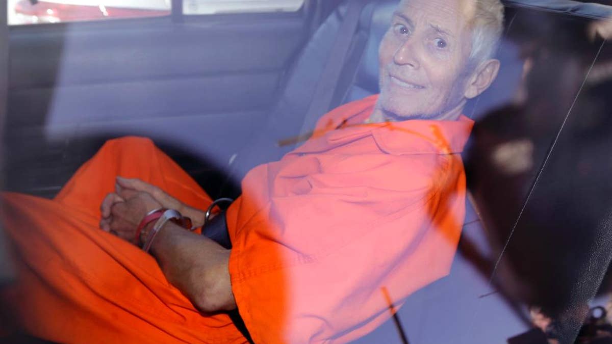 Robert Durst is transported from Orleans Parish Criminal District Court to the Orleans Parish Prison after his arraignment in New Orleans, Tuesday, March 17, 2015. Durst was rebooked on charges of being a convicted felon in possession of a firearm, and possession of a weapon with a controlled dangerous substance, a small amount of marijuana. (AP Photo/Gerald Herbert)