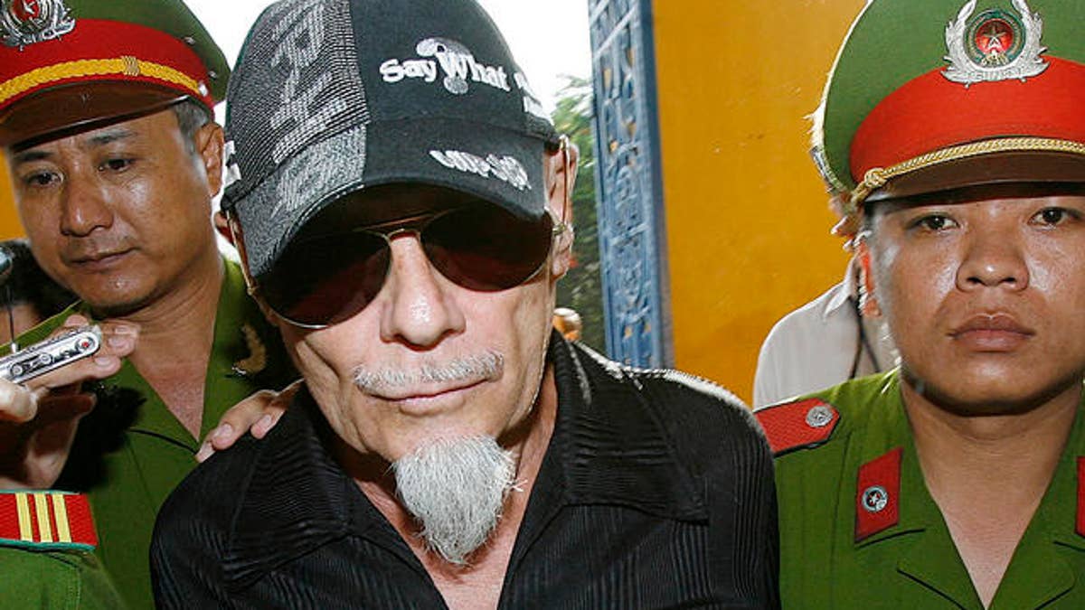 British rocker Gary Glitter is led into court in Ho Chi Minh city, Vietnam on Thursday June 15,2006. Glitter went before a Vietnamese court Thursday to appeal convictions and a three-year prison  sentence for molesting young girls at a seaside villa in southern Vietnam. (AP Photo/Richard Vogel)