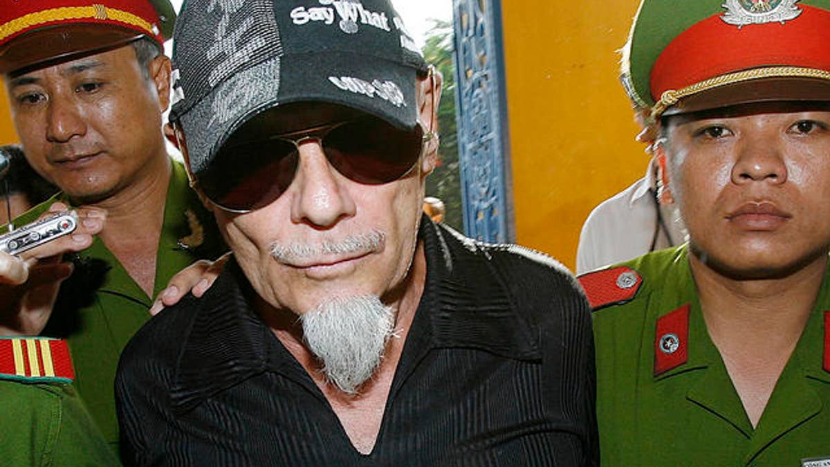 British rocker Gary Glitter is led into court in Ho Chi Minh city, Vietnam on Thursday June 15,2006. Glitter went before a Vietnamese court Thursday to appeal convictions and a three-year prison  sentence for molesting young girls at a seaside villa in southern Vietnam. (AP Photo/Richard Vogel)